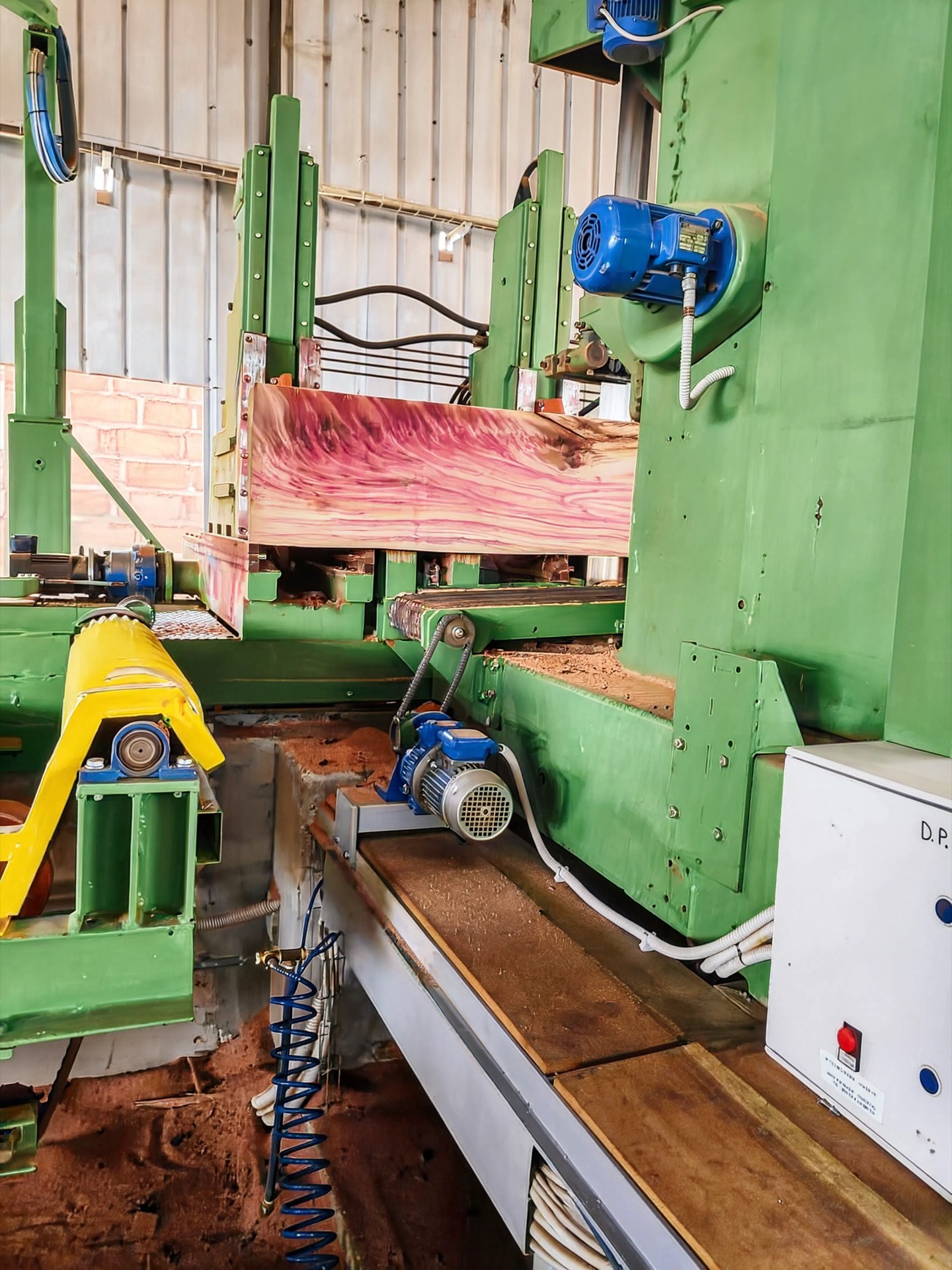 Bandsaw cutting a hardwood log to dimension